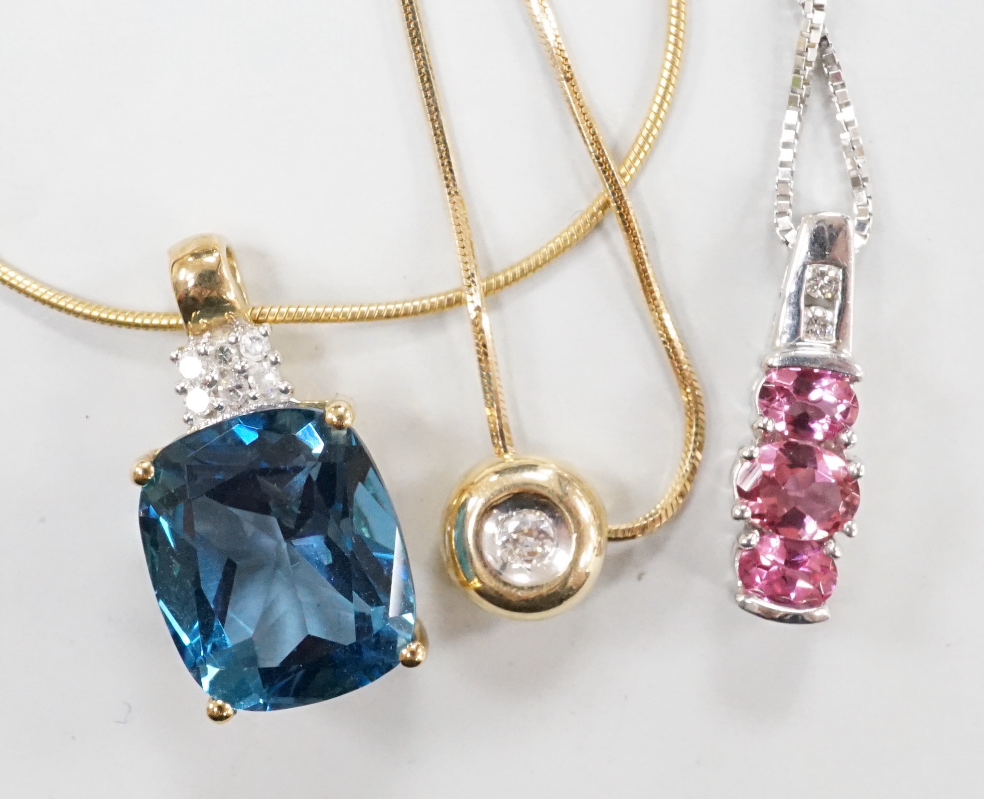 Three assorted modern 9ct gold and gem set pendant necklaces, including blue topaz and diamond chip, 46cm, gross weight 11.7 grams.
